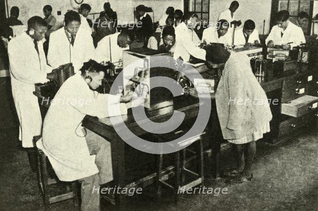 'Scenes in a Native College - Students in the physics laboratory', c1948. Creator: Unknown.