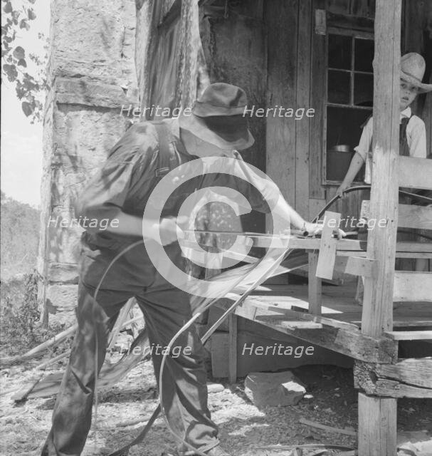 In Arkansas Hills (Ozarks) near Seligman, Missouri, splitting hickory for chair-bottoms, 1938. Creator: Dorothea Lange.