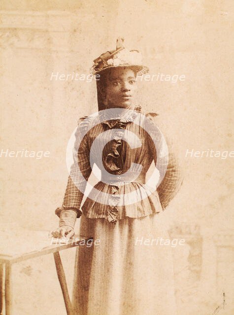 Woman in hat decorated with flowers, and striped blouse, (1900-1950?). Creator: Madison Art Studio.