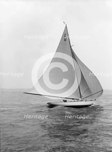 'Wamba II' running downwind under spinnaker, 1914. Creator: Kirk & Sons of Cowes.