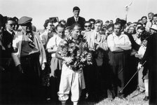 Stirling Moss, winner of the British Grand Prix, Aintree, 1955. Artist: Unknown