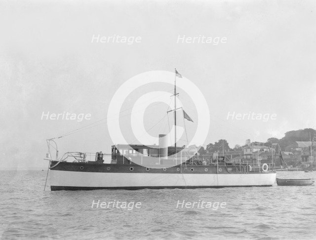 The 28 ton motor yacht 'Edina' at anchor, 1921. Creator: Kirk & Sons of Cowes.