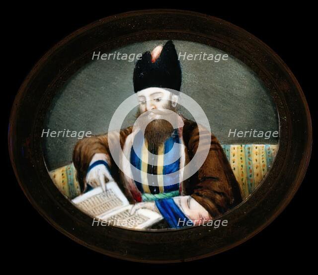An Indian (?) man seated, reading a book. Creator: Unknown.