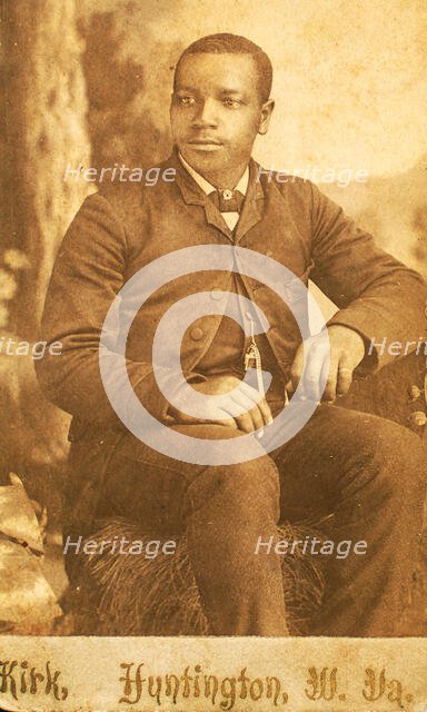 Studio portrait of unidentifed young man, seated on prop hay bale, c1870-c1879. Creator: George Wolleston Kirk.