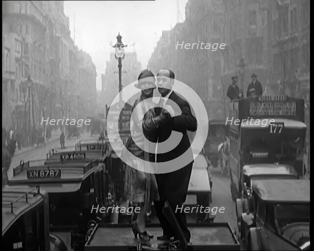 A Couple Dancing the Charleston on the Top of a Car Driving Down a London Street, 1926. Creator: British Pathe Ltd.