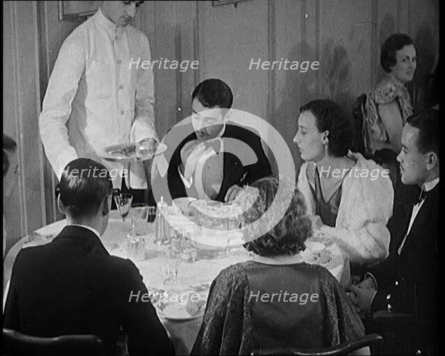 Upper Class People Enjoying a Meal in a Restaurant, 1931. Creator: British Pathe Ltd.