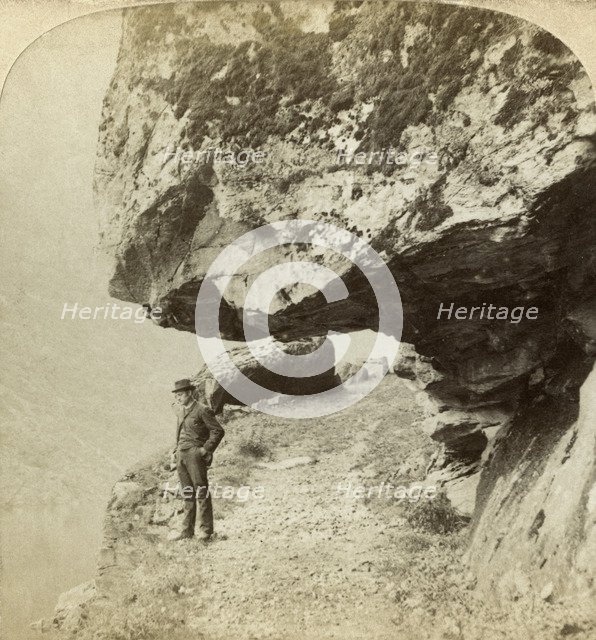 Man on a cliff overlooking Naeroyfjord, Sogne, Norway. Creator: Bert Underwood.