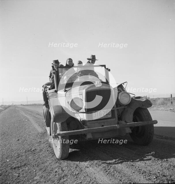 Eight related persons...in search of employment as pea pickers, on US80, Imperial Valley, CA, 1939. Creator: Dorothea Lange.
