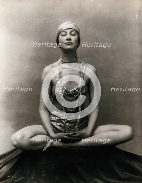 Marguerite Agniel posing with her legs crossed and hands together resting on her legs, 1929. Creator: Unknown.