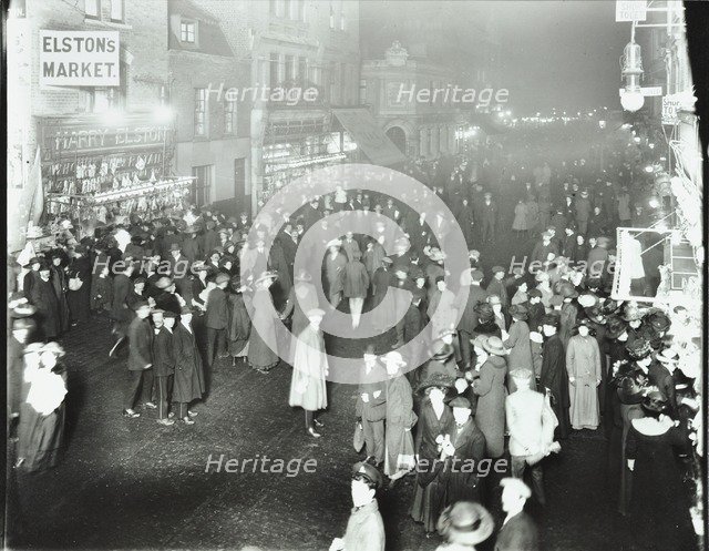 Crowds in Deptford High Street shopping after dark, London, 1913. Artist: Unknown.