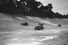 Cars racing on the banking at a JCC Members Day, Brooklands. Artist: Bill Brunell.