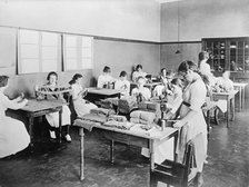 Red Cross Garment Division, Misc. Views of Work Rooms And Women Sewing, Knitting, Etc., 1917. Creator: Harris & Ewing.