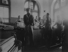 Workers wetting sheets prior to printing paper money at the Bureau of Engraving & Printing, c1895. Creator: Frances Benjamin Johnston.