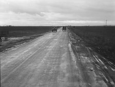 County road between potato fields, Kern County, California, 1939. Creator: Dorothea Lange.