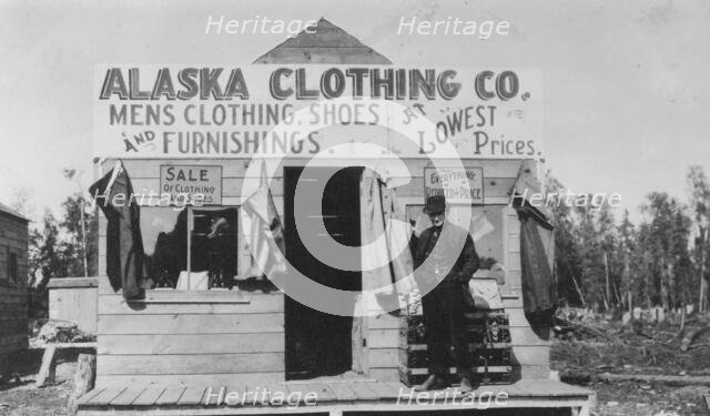 Man in front of Alaska Clothing Co. store, between c1900 and 1916. Creator: Unknown.