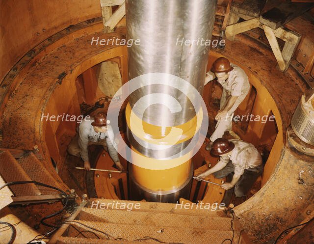 Checking the alignment of a turbine shaft at the top of the guide..., Watts Bar Dam, Tenn., 1942. Creator: Alfred T Palmer.
