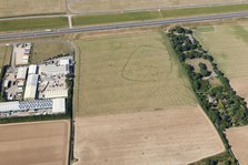 Enclosure and ring ditch crop marks near Minster, Kent, 2015. Creator: Historic England.