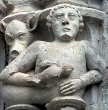 Detail of a capital showing a man with a pigeon in the hand, in the cloister of the Monastery of …