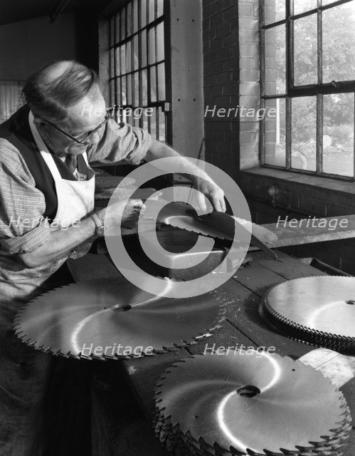 Tensioning circular saws at Slack Sellers & Co Ltd, Sheffield, 1963.  Artist: Michael Walters