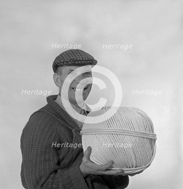 Yorkshireman wearing a flat cap and holding a large ball of twine, 1968. Artist: Michael Walters