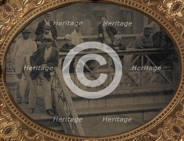 Group of Men and Boys Standing Along the Railing of the Fulton Street Bridge, 1866-68. Creator: Unknown.