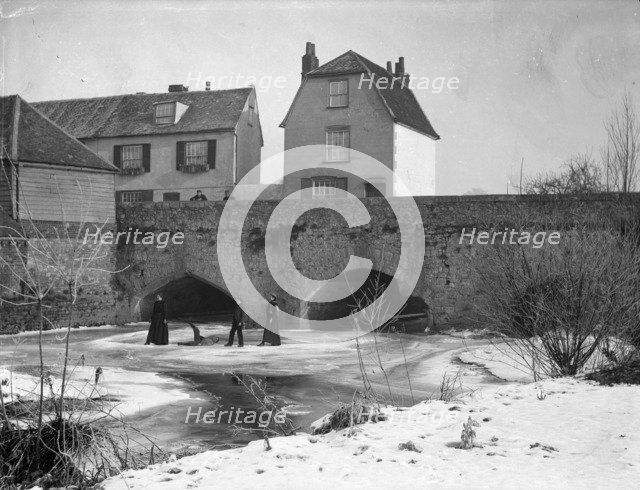 A group skating on the frozen River Thames, Abingdon Bridge, Abingdon, Oxfordshire, c1860-c1922. Artist: Henry Taunt
