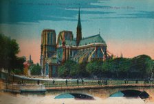 Notre-Dame Cathedral showing the Apse and the Pont Notre-Dame, Paris, c1920. Artist: Unknown.