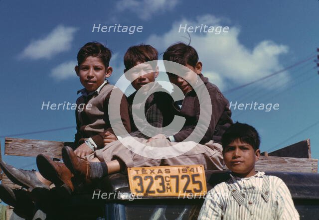 Boys sitting on truck parked at the FSA ... labor camp, Robstown, Tex., 1942. Creator: Arthur Rothstein.