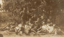 Soldiers relaxing in a field, (between 1910 and 1919?). Creator: Unknown.