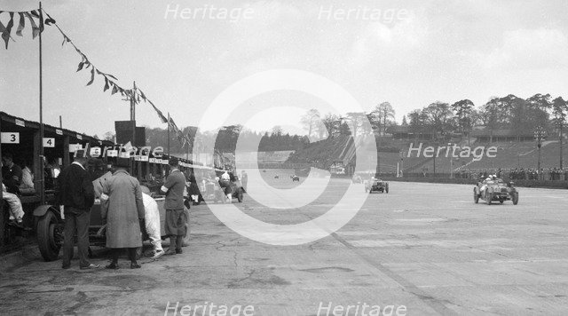 Invicta leading a Riley 9 Brooklands in the JCC Double Twelve race, Brooklands, 8/9 May 1931. Artist: Bill Brunell.
