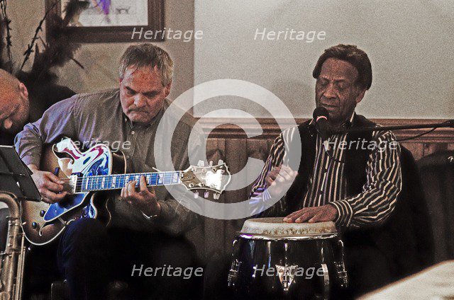Frank Holder, Guyanan jazz singer and percussionist with Shane Hill, The Castle, Outwood, Surrey.    Artist: Brian O'Connor