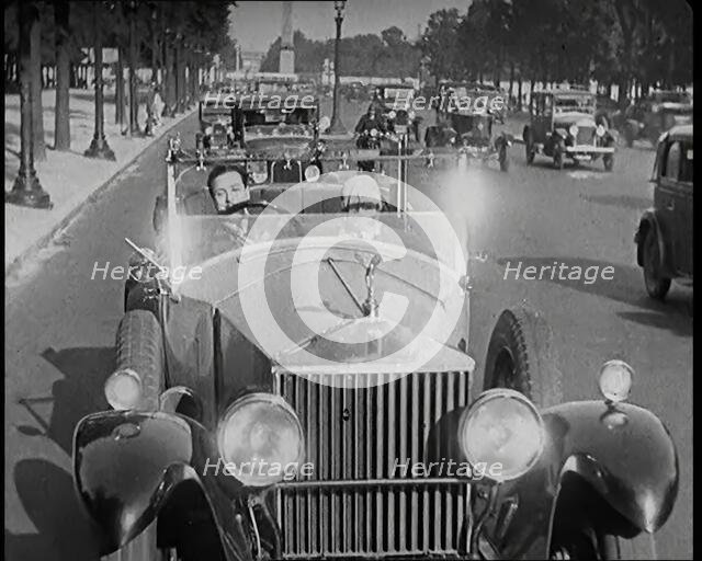 Scene from the Film 'The Compulsory Husband': The Actor Monty Banks Driving a Car With..., 1920s. Creator: British Pathe Ltd.