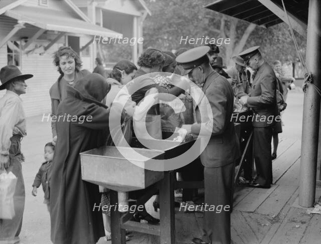 State border plant inspection between Mexico and the United States, 1937. Creator: Dorothea Lange.