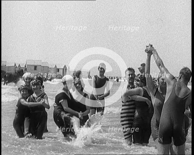 Civilians Wearing Swimsuits Enjoying a Sunny Day Dancing at a Very Crowded Beach, 1920. Creator: British Pathe Ltd.