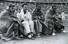 Athletes Frank Wykoff, Paul Hanni, Ralph Metcalfe and Jesse Owens, Berlin Olympics, 1936. Artist: Unknown