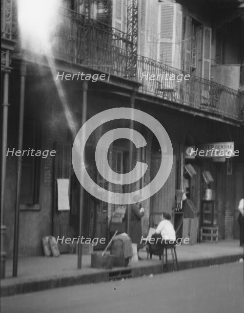 View from across street of two women talking, New Orleans, between 1920 and 1926. Creator: Arnold Genthe.