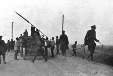 'Les Fuyards; Un auto camion emportant des soldats avec un drapeau est evacué par..., 1917. Creator: Unknown.