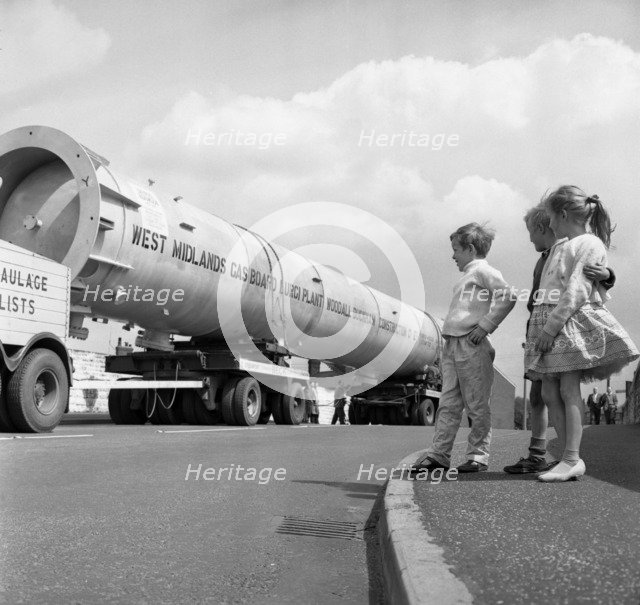 An absorption tower being transported by road, Dukenfield, Manchester, 1962. Artist: Michael Walters