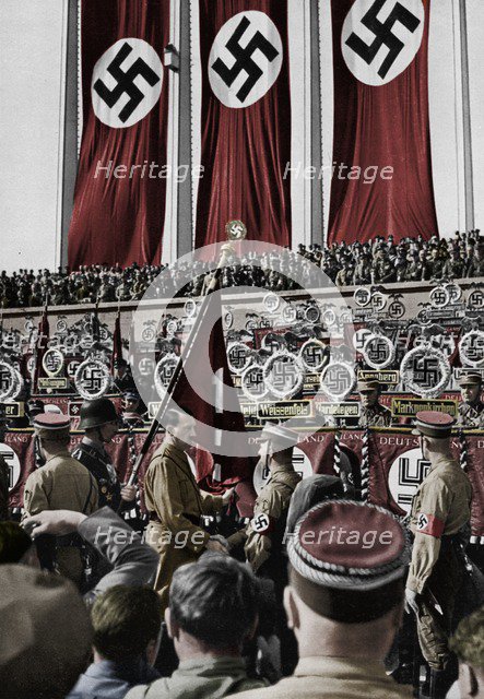 Adolf Hitler dedicates new standards, Nuremberg Rally, Germany, 1934.  Artist: Unknown.