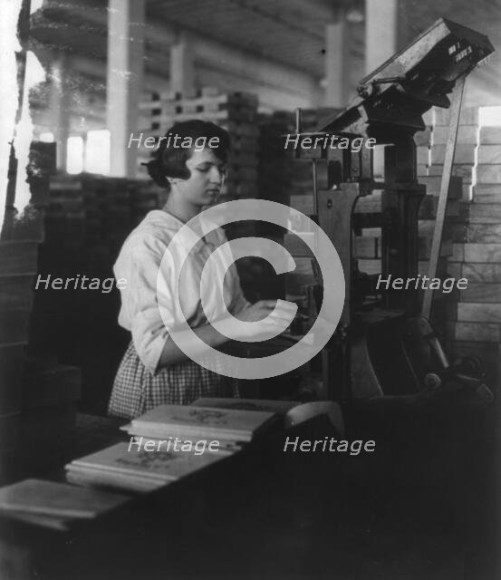 Wooden Box Industry: young woman working at machine, c1910. Creator: Frances Benjamin Johnston.
