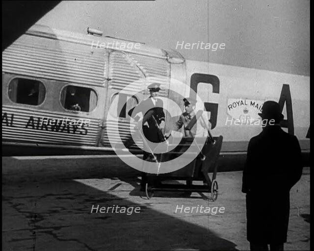 Three Men Tending to a Plane on the Ground, 1933. Creator: British Pathe Ltd.
