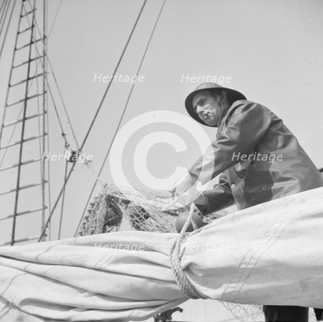 A New England fisherman preparing his boat to leave the New York docks, 1943. Creator: Gordon Parks.