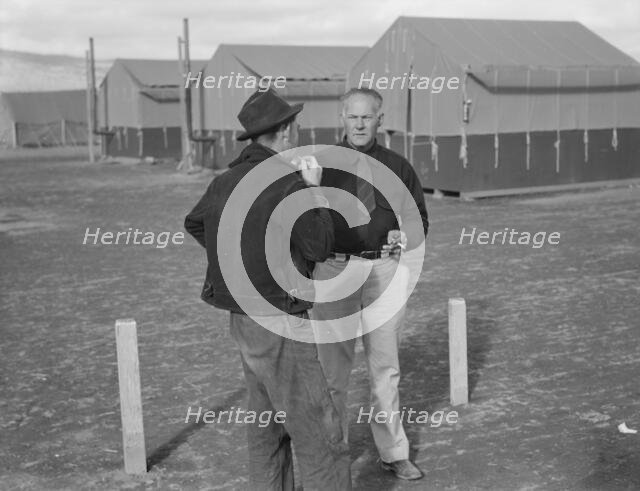 Camp manager talking to another man, FSA mobile camp, Merrill, Klamath County, Oregon, 1939. Creator: Dorothea Lange.