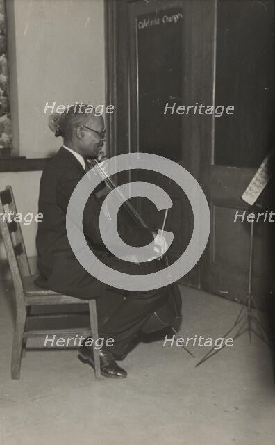 A cello student of the Adult Education Classes under the Federal Music Project at Carlton YMCA, 1936 Creator: Unknown.