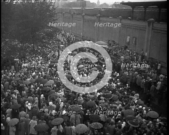 Masses of People Cheering - Many Have Umbrellas As It Is Raining, 1932. Creator: British Pathe Ltd.