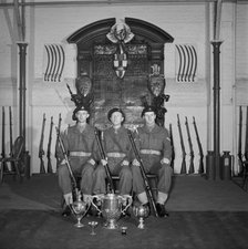 Three soldiers are posed in front of the Honourable Artillery Company's war memorial, c1945-c1965. Artist: SW Rawlings