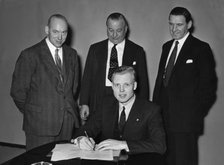 Mike Hawthorn signing Vanwall contract 1955. Creator: Unknown.