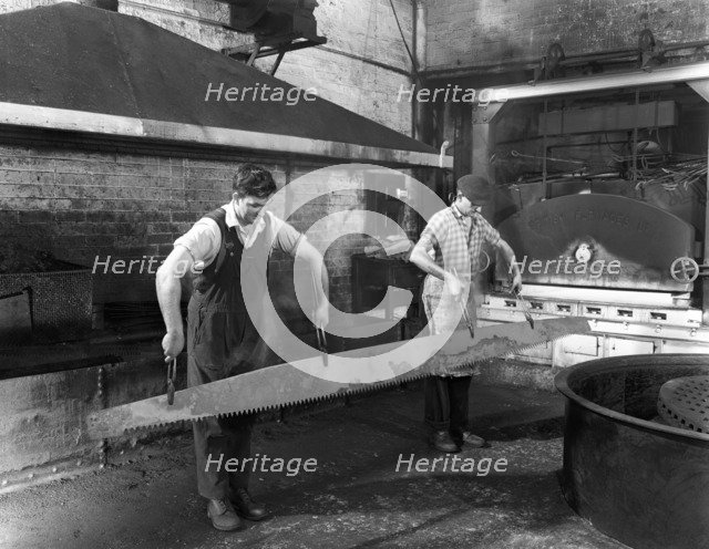 Heat treating a two metre saw blade, Slack Sellars & Co Ltd, Sheffield, South Yorkshire, 1963. Artist: Michael Walters