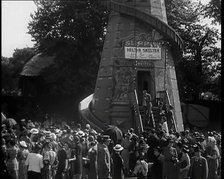 A Helter Skelter Fairground Ride in a Park With a Man at  the Entrance With a Megaphone..., 1939. Creator: British Pathe Ltd.