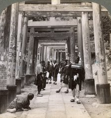 Coming and going under long rows of sacred torii, Shinto temple of Inari, Kyoto, Japan, 1904. Artist: Underwood & Underwood